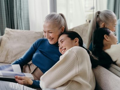 elderly woman and young woman laughing together